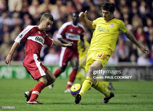 Middlesbrough, UNITED KINGDOM: Middlesbrough's James Morrison vies for the ball with Liverpool's Xabi Alonso right during their English Premiership...