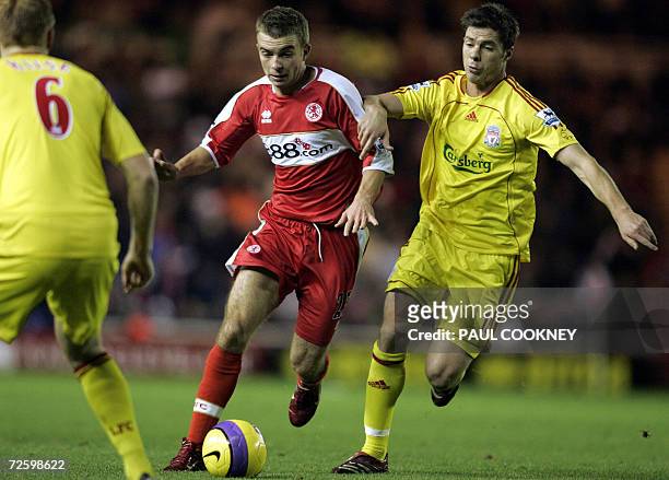 Middlesbrough, UNITED KINGDOM: Middlesbrough's James Morrison battles with Liverpool's Xabi Alonso during their English Premiership football match at...