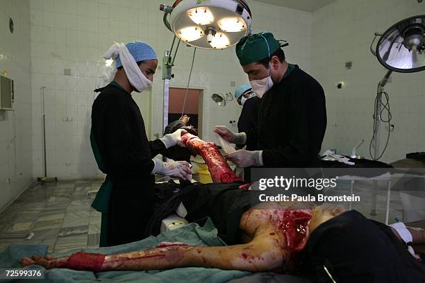 Doctor Hamayun Azizi performs a skin graft operation on Panwasha a self immolation victim at the Herat Regional hospital November 15, 2006 in Herat,...