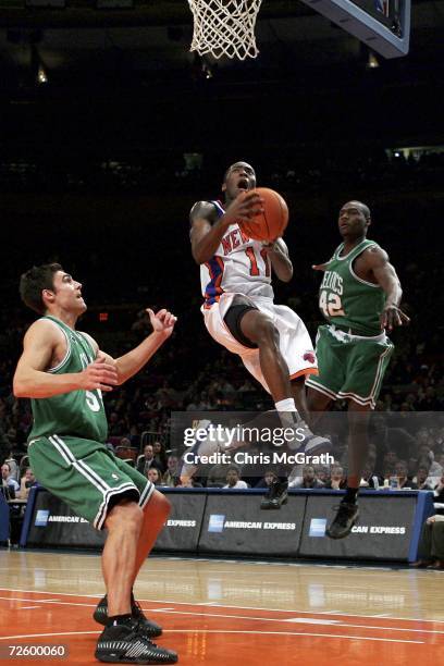 Jamal Crawford of the New York Knicks drives to the basket passed Tony Allen and Wally Szcerbiak of the Boston Celtics on November 18, 2006 at...