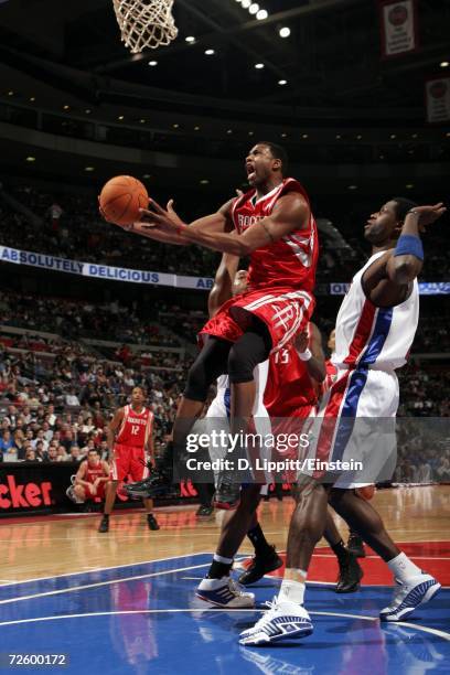 Tracy McGrady of the Houston Rockets shoots past Antonio McDyess of the Detroit Pistons during a game on November 18, 2006 at the Palace of Auburn...