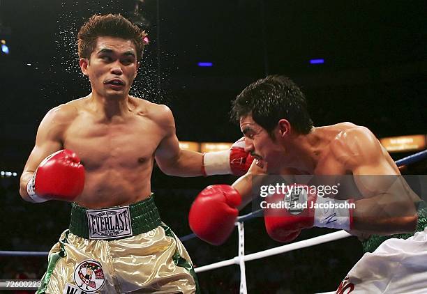 Brian Viloria throws a left hook at Omar Nino of Mexico after taking a punch during their light flyweight bout at the Thomas & Mack Center on...