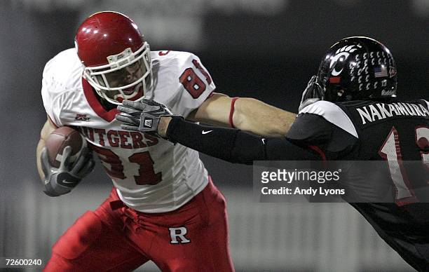 Haruki Nakamura of the Cincinnati Bearcats grabs the face mask of Clark Harris of the Rutgers Scarlet Knights during the game on November 18, 2006 at...