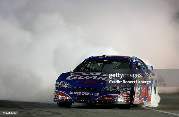 Kevin Harvick, driver of the U.S. Coast Guard Chevrolet, performs a burnout on the track after winning the NASCAR Busch Series Championship,...