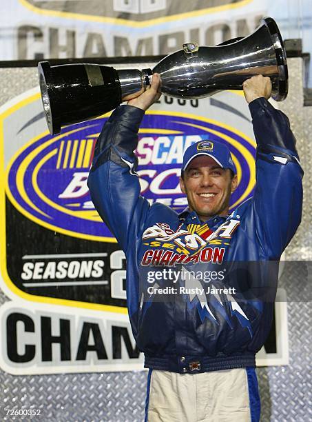 Kevin Harvick, driver of the U.S. Coast Guard Chevrolet, holds the Busch Series Champions trophy after winning the NASCAR Busch Series Championship,...