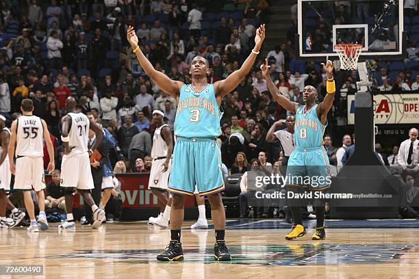 Chris Paul and Bobby Jackson of the New Orleans/Oklahoma City Hornets celebrate the moment after the winning basket sinks in the game against the...