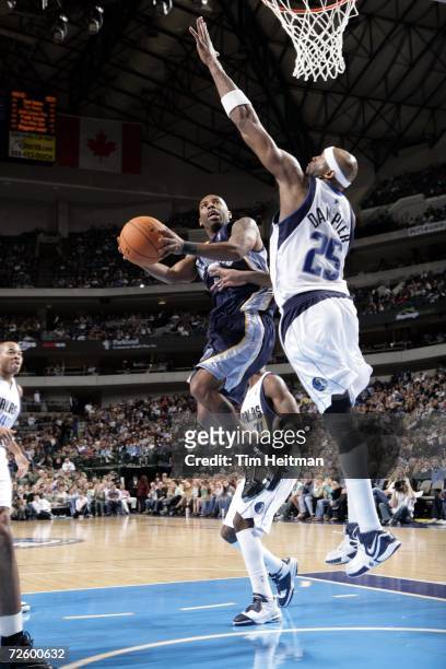 Chuck Atkins of the Memphis Grizzlies tries to put it around Erick Dampier of the Dallas Mavericks on November 18, 2006 at the American Airlines...