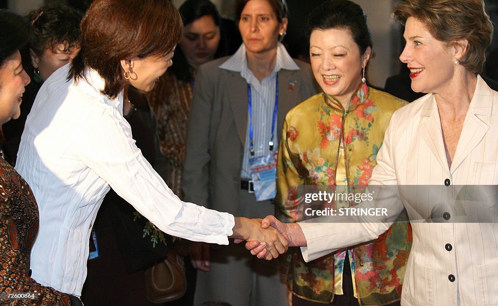 Akie Abe (L) from Japan shakes hands wit