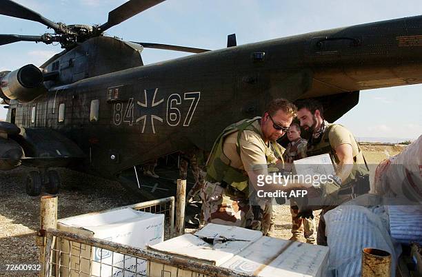 Norwegian soldiers, part of the International Security Assistance Force ,load humanitarian aid from the Afghan Ministry of Public Health's onto a...