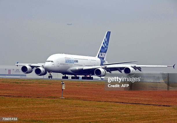 The double-decker superjumbo Airbus A380 jet arrives at Narita Airport in Chiba prefecture, suburban Tokyo, 19 November 2006, as a part of its...