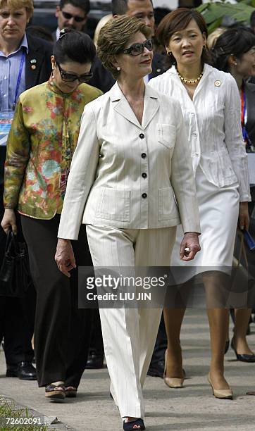 First Lady Laura Bush walks with Japanese Prime Minister Shinzo Abe's wife Akie Abe and Taiwan representative Morris Chang's wife Sophie Chang during...