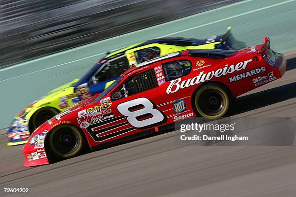 Dale Earnhardt Jr., driver of the Budweiser Chevrolet, races Kyle Busch, driver of the Kellogg's Chevrolet, during the NASCAR Nextel Cup Series Ford...