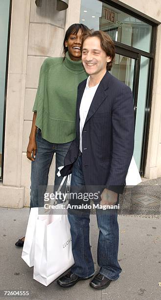 Model Oluchi Onweagba and designer Luca Orlandi pose in front of his store ''Luca Luca'' on Madison Avenue on November 19, 2006 in New York City.