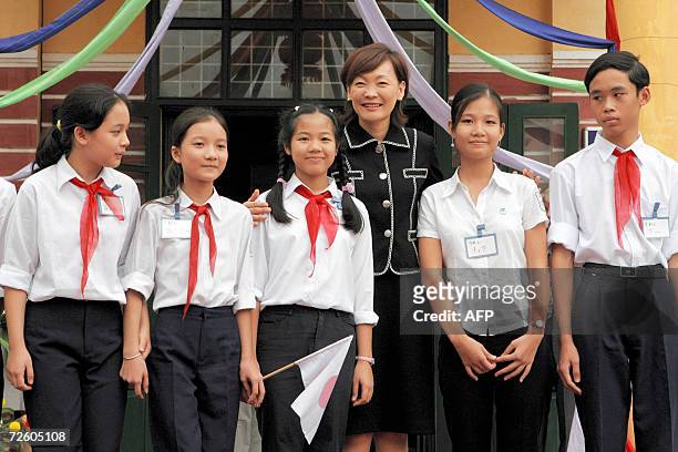 Akie Abe , the wife of visiting Japanese Prime Minister Shinzo Abe, poses with students in a photo session while visiting the Chu Van An Lower...