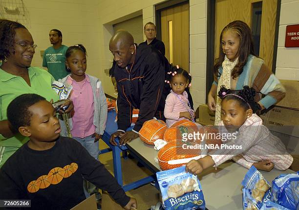 Bobby Jackson of the New Orleans/Oklahoma City Hornets and his family hand out Thanksgiving meals to families on November 19, 2006 at the Boys and...