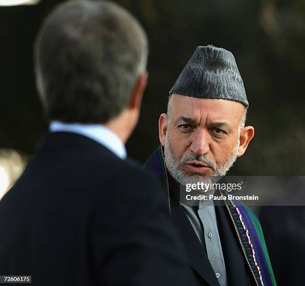 British Prime Minister Tony Blair speaks with Afghan President Hamid Karzai during a meeting with the media on November 20, 2006 at the presidential...