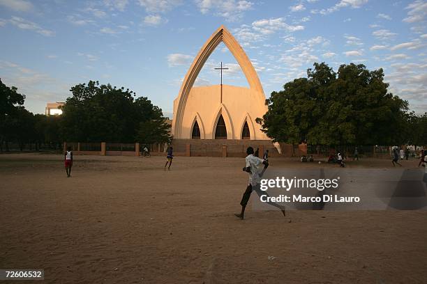 Chadian teenagers play football in front of the main Catholic Cathedral on November 3, 2006 in N'Djamena, Chad. Chad declared a state of emergency in...