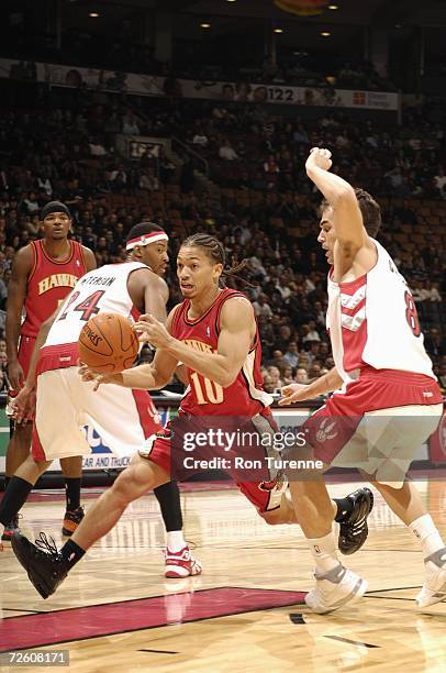 Tyronn Lue of the Atlanta Hawks drives to the basket against Jose Calderon of the Toronto Raptors during a game at Air Canada Centre on November 10,...