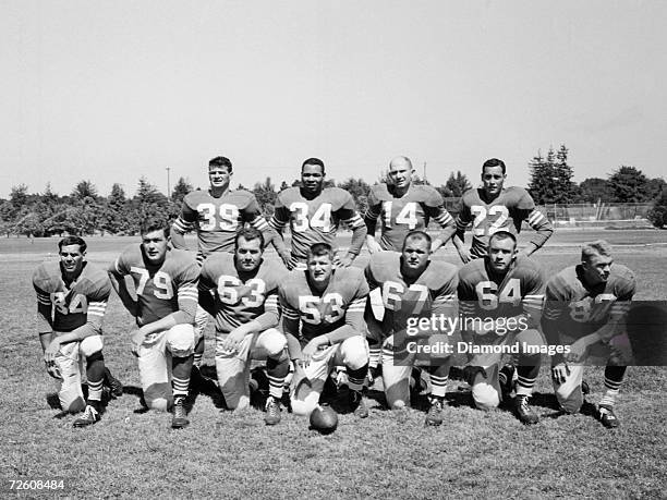 Members of the offense for the San Francisco 49ers pose for a team portrait prior to a training camp workout in August, 1954 in Santa Clara,...