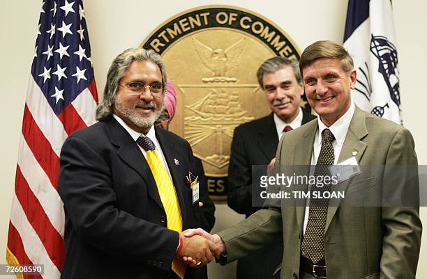 Washington, UNITED STATES: Dr. Vijay Mallya , chairman and CEO of Kingfisher Airlines, shakes hands with Stephen Finger , president of Pratt &...