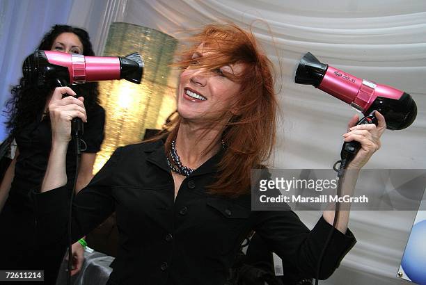 Comedian Kathy Griffin poses with the Dr. Spela Hair display backstage at the American Music Awards with distinctive assets held at the Shrine...
