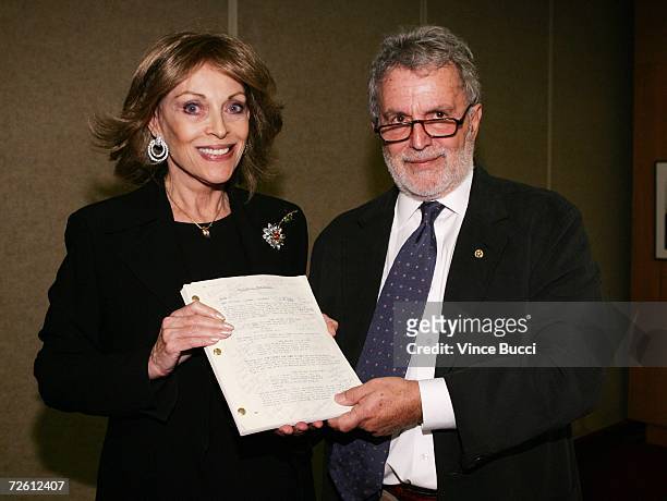 Actor Gregory Peck's widow, Veronique Peck and AMPAS President Sid Ganis pose with Peck's annotated script from the film "To Kill A Mockingbird" at...