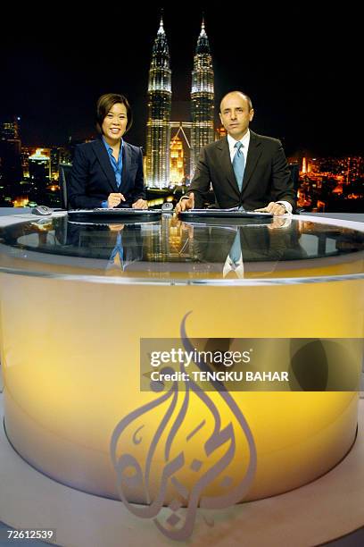 Kuala Lumpur, MALAYSIA: Al-Jazeera news anchors Veronica Pedrosa and Teymoor Nabili pose for photographs on set at the Al Jazeera broadcast centre in...