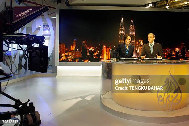 Kuala Lumpur, MALAYSIA: Al-Jazeera news anchors Veronica Pedrosa and Teymoor Nabili pose for photographs on set at the Al-Jazeera broadcast centre in...