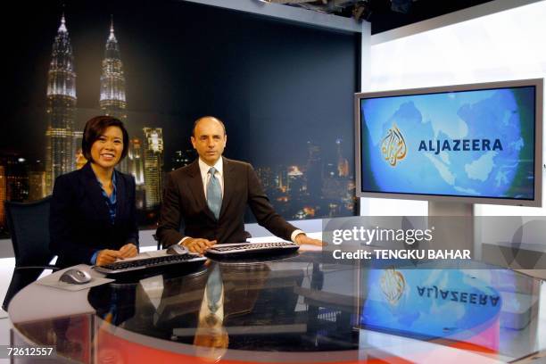 Kuala Lumpur, MALAYSIA: Al-Jazeera news anchors Veronica Pedrosa and Teymoor Nabili pose for photographs on set at the Al-Jazeera broadcast centre in...