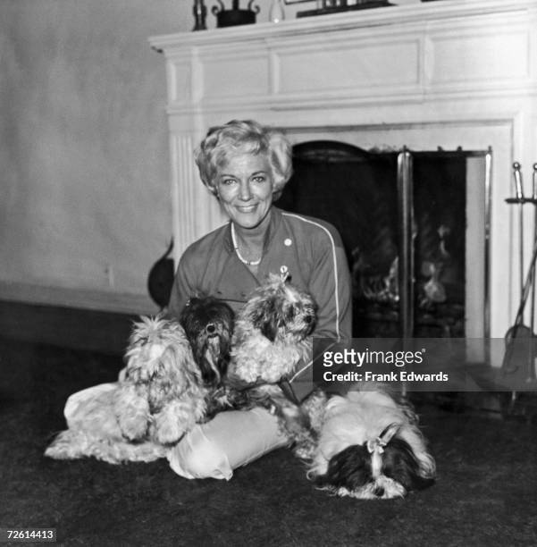 American actress Jeanne Cooper at home with her four pet dogs, Jezebel, Kissy, Colin and Dean, April 1977.