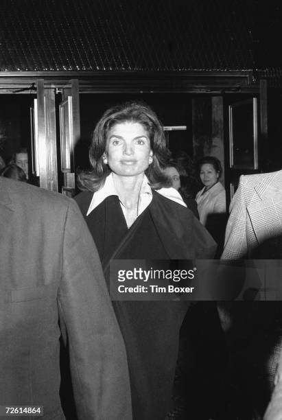 Former American First Lady Jacqueline Kennedy Onassis walks through the crowd in the lobby of the Ziegfeld Theatre after an invitational advanced...