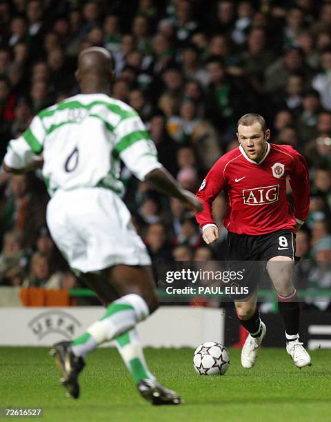 Manchester United's Wayne Rooney closes in on Celtic's Dianbobo Balde during their UEFA Champions League group F football match at Celtic Park,...