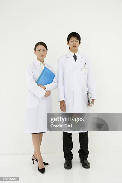 portrait of scientists holding files, looking at camera, front view, white background - scientist full length stock pictures, royalty-free photos & images