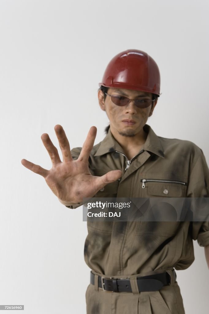 Worker showing palm, Front View