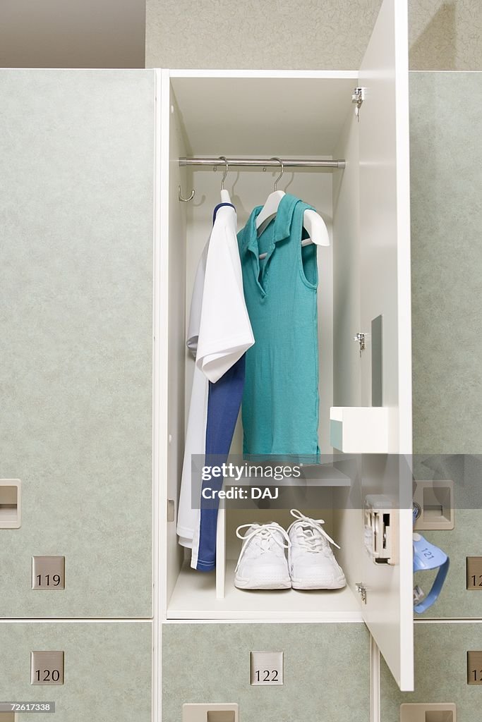 Sports shoes and shirts in a locker, front view