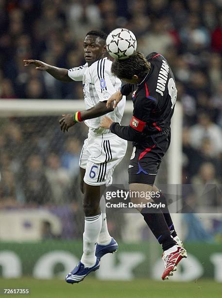 Mahamadou Diarra of Real Madrid and Juninho Pernambucano of Lyon challenge for the ball during the UEFA Champions League Group E match between Real...