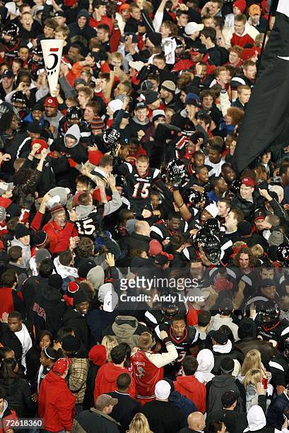 Kevin Lovell of the Cincinnati Bearcats celebrates as he is hoisted by fans after winning the game against the Rutgers Scarlet Knights during the...