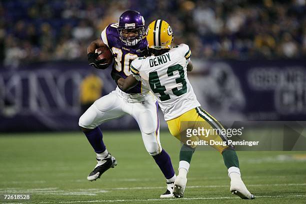 Running back Mewelde Moore of the Minnesota Vikings runs with the ball against cornerback Patrick Dendy of the Green Bay Packers on November 12, 2006...