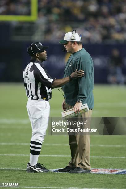 Side judge Michael Banks talks to head coach Mike McCarthy of the Green Bay Packers during the game against the Minnesota Vikings on November 12,...