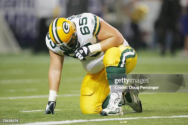 Offensive tackle Mark Tauscher of the Green Bay Packers kneels on the ground during the game against the Minnesota Vikings on November 12, 2006 at...