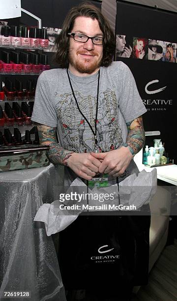 Drummer Andrew Hurley of the group Fall Out Boy poses with the Creative Nail Design display backstage at the American Music Awards with distinctive...