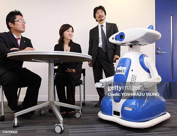 Japanese robot maker Tmsuk President Yoichi Takamoto introduces the robot "Ubiko" which can recognize human voice and speaks to guests as a guide or...