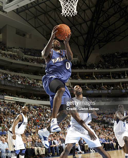 Gilbert Arenas of the Washington Wizards goes in for the layup against Greg Buckner of the Dallas Mavericks on November 21, 2006 at the American...