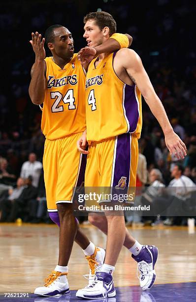 Kobe Bryant and Luke Walton of the Los Angeles Lakers walk back to the bench after defeating the Los Angeles Clippers during the game on November 21,...