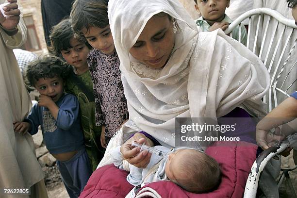 Malaika Salah, age 25, HIV positive and from the Tribal belt of western Pakistan, gives anti-retroviral medication to her newborn son Yasin on April...