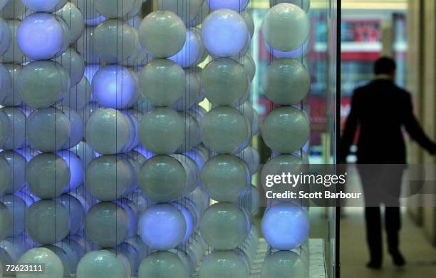 Man walks past the specially commissioned sculpture called 'The Source', by artists Greyworld in the atrium at the London Stock Exchange on November...