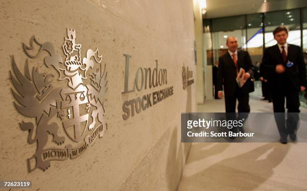 People walk past the logo of the London Stock Exchange inside of the London Stock Exchange offices on November 22, 2006 in London, England. The...