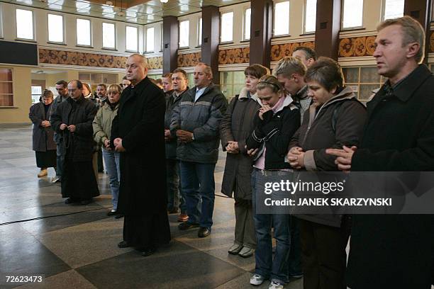 People pray in a chapel inside the Halemba coal mine in Ruda Slaska 22 November 2006. Rescue efforts were still underway after at least eight miners...