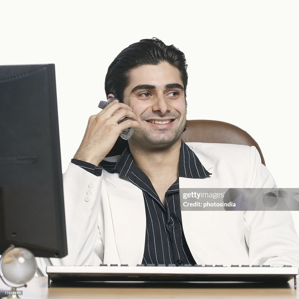 Close-up of a businessman talking on a cordless phone