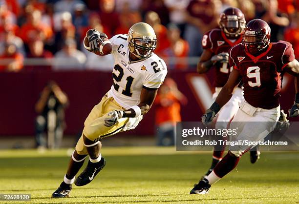 Wide Receiver Calvin Johnson of the Georgia Tech Yellow Jackets runs with the ball as Vince Hall of the Virgina Tech Hokies defends on September 30,...